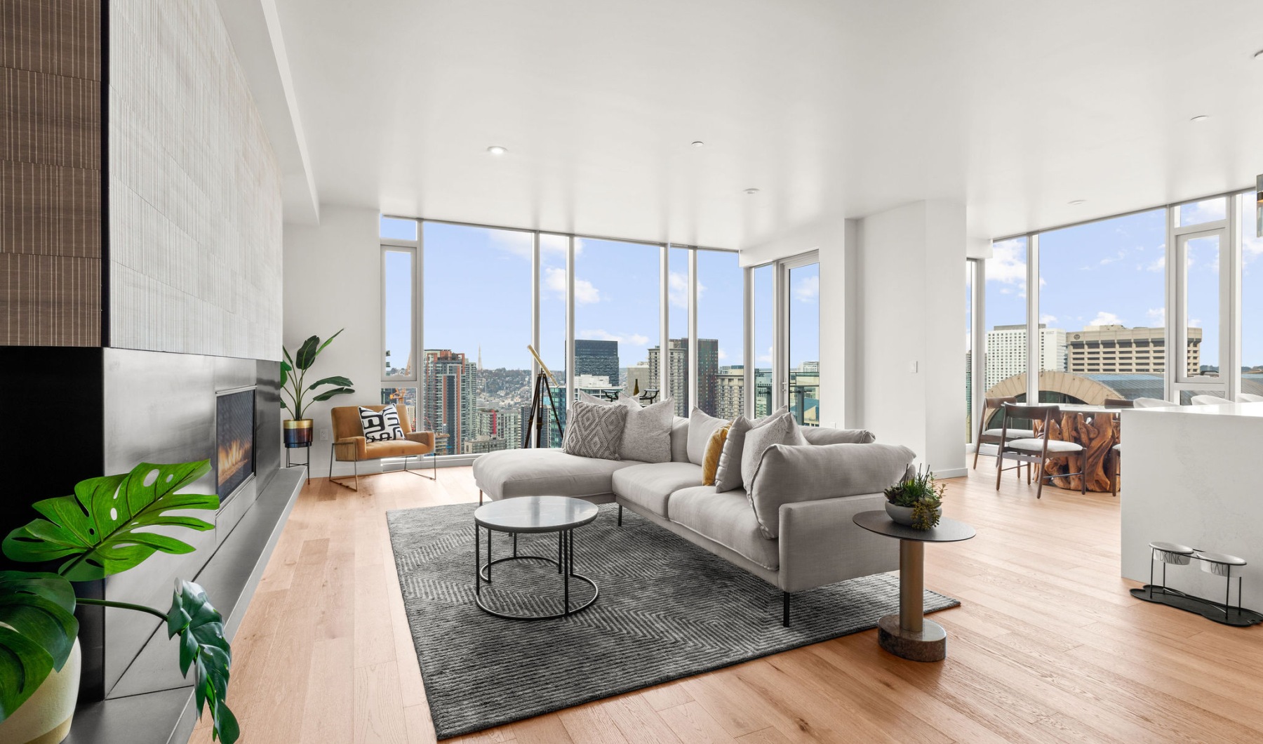 a living room with a couch, chairs and table
