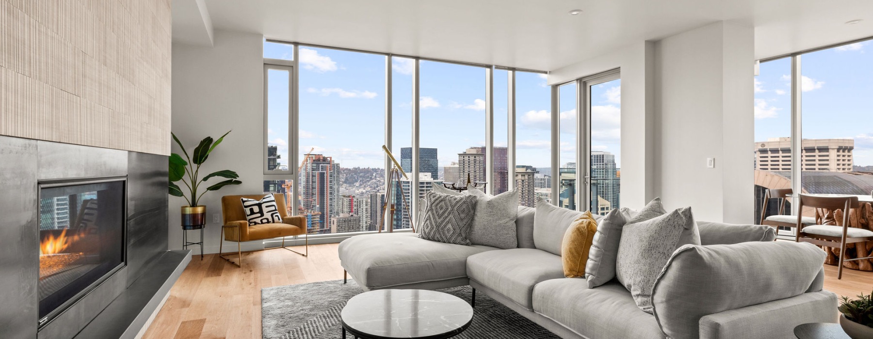 a living room with a couch, fireplace and a table