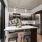 Dog-Friendly Apartments in Downtown Seattle, WA - West Edge - Spacious Living Room with Wood-Style Flooring, Armchair, L-Shaped Couch, Coffee Table, Wooden TV Stand with a TV, and Expansive Floor-to-Ceiling Windows