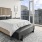 1, 2, & 3-BR Apartments In Downtown Seattle, WA - Spacious Bedroom With Hard Surface Flooring, High Ceilings, And Floor To Ceiling Windows With City Views.